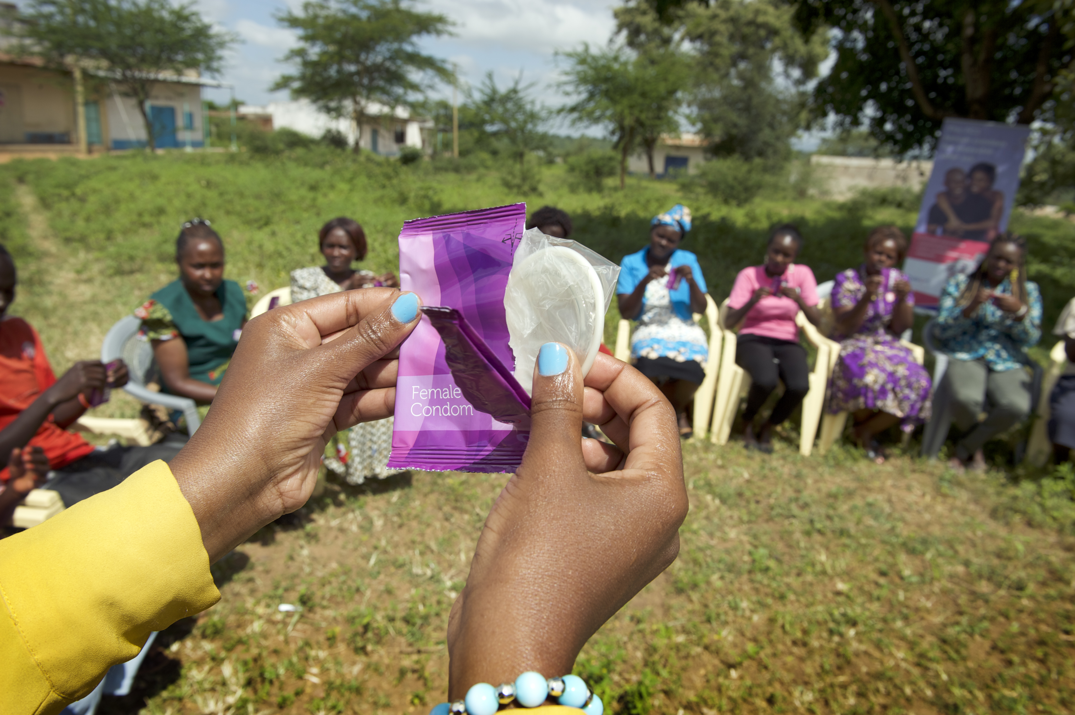 Image of woman opening an FC2 Female Condom sachet during a field training